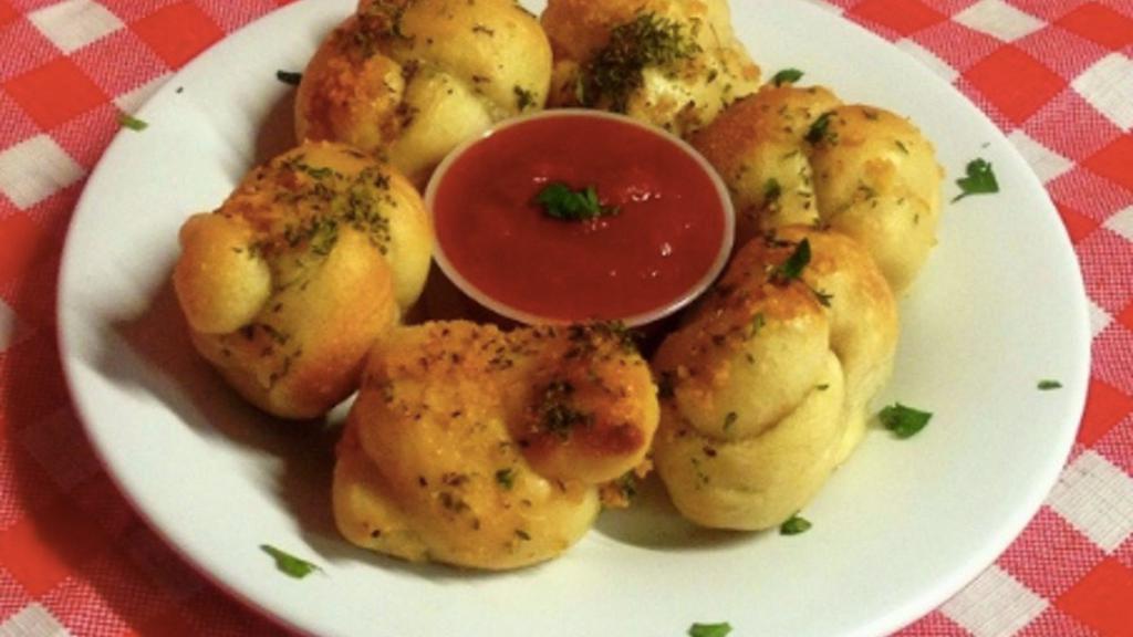 Garlic Knots With Tomato Sauce · Bread, topped with garlic, herb seasoning, baked to perfection.