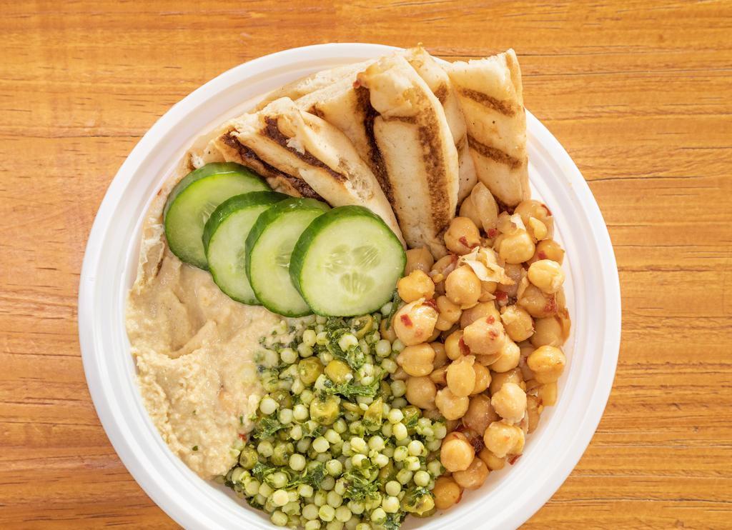 Detox Moroccan-Spiced Chickpea Glow Bowl · perfect blend of protein and flavor, spiced chick peas with spices, chopped cucumbers, couscous, cilantro, hummus, olive oil & lemon juice