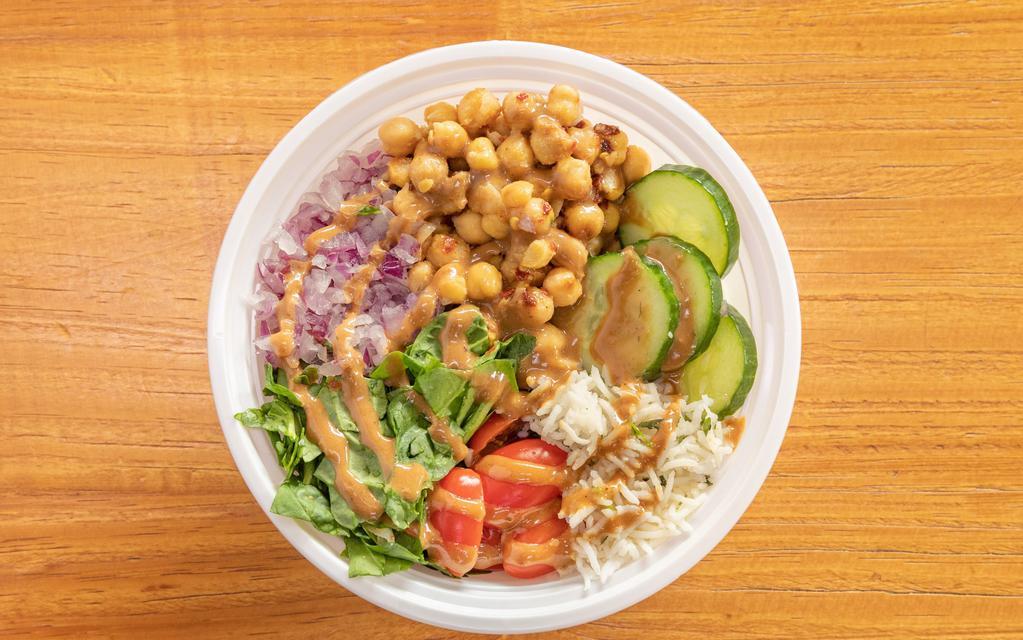 Mediterranean Chickpea Bowls With Peanut Dressing · Mediterranean chickpea bowls with creamy peanut sauce! Made with spiced chickpeas, spinach, cherry tomatoes, cucumbers, red onions, and cilantro lime rice