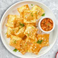 Fried Ravioli · (Vegetarian) Cheese-filled ravioli breaded and fried until golden brown. Served with housema...
