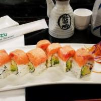 Spicy Tuna California Roll · Crabstick, avocado, and cucumber wrapped inside out with spicy tuna on top.