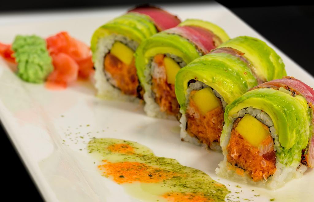 Dynamite Roll · Spicy tuna and mango wrapped inside out. Topped with pepper tuna, avocado, and wasabi sauce.