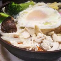 Nabeyaki Udon · Big bowl of udon, noodles soup with chicken, egg, fishcakes, vegetable, and one piece of shr...