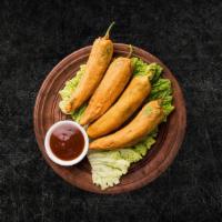 Golden Fried Chili Fritters (Vegan) · Fresh large green chilies, hollowed, seasoned and batter fried till crisp and golden.