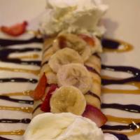 Fruit Crêpe · Tablespoons of Nutella onto each crepe, add fresh fruit and a coffee