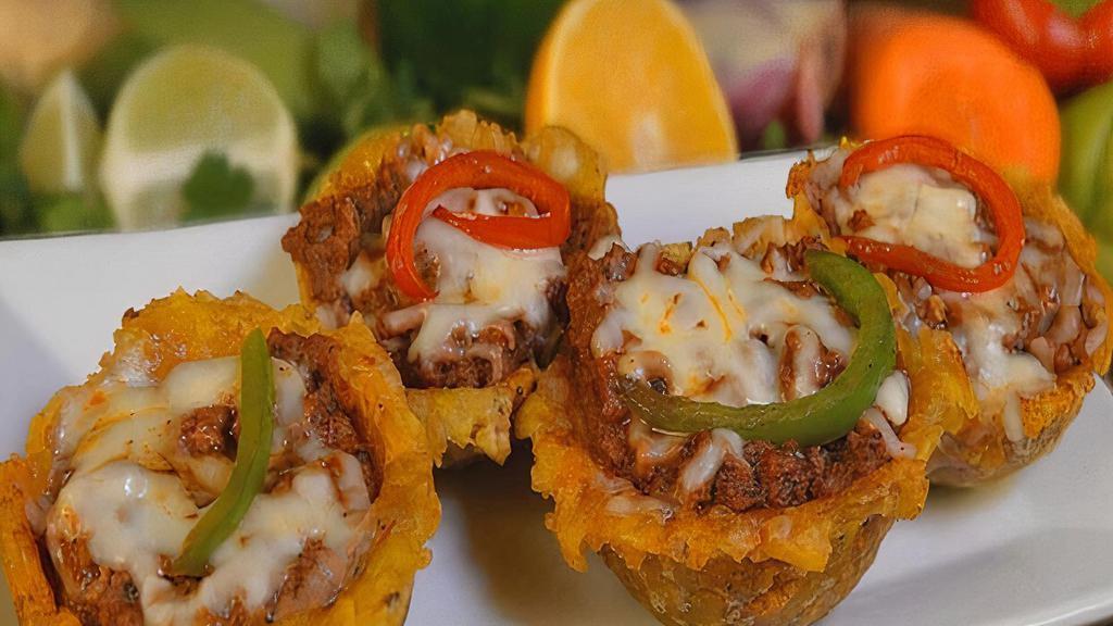 Tostones Rellenos · Fried plantains topped with your choice of shrimp, ground beef, or chicken.