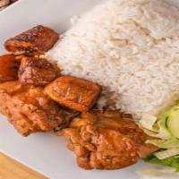 Stew Chicken (Pollo Guisado) · Stew chicken cooked in tomato-based sauce served with two sides.