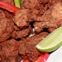 Fried Chicken Bone-In (Chicharron De Pollo) · Fried chicken chunks with bones served with two sides.