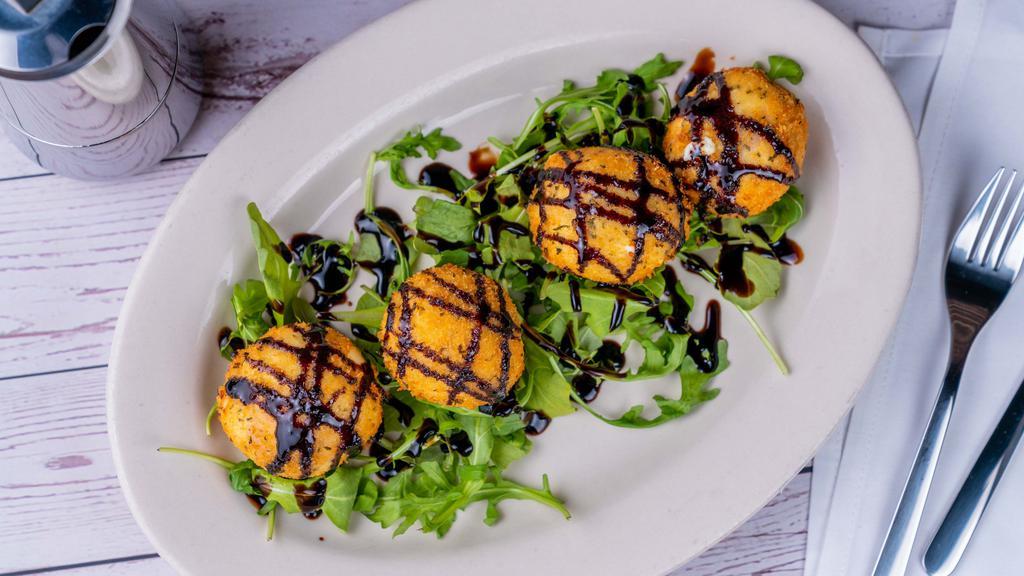 Goat Cheese Fritters · Goat cheese and imported ham filled croquettes drizzled with balsamic glaze