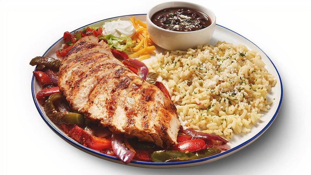 New! Chicken Fajitas · Grilled chicken seasoned with our special blend of Mexican spices.  Served on a bed of grilled peppers & onions, with rice, seasoned black beans, shredded lettuce, sour cream, pico de gallo, cheddar cheese, and flour tortillas