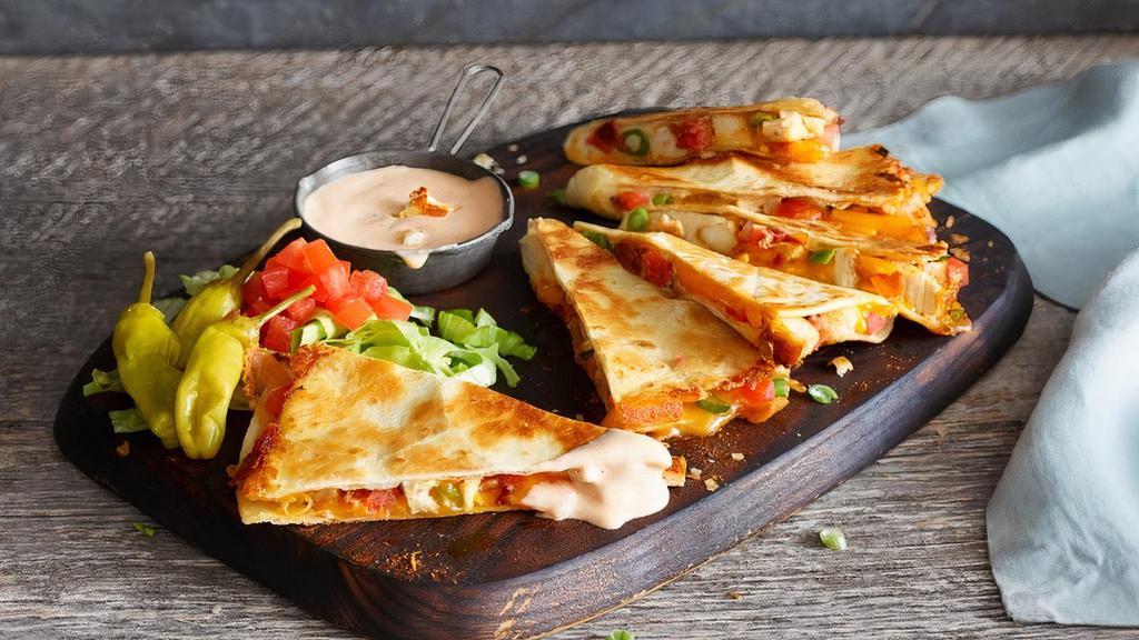 Chicken Quesadilla · Blackened chicken, cheddar cheese, tomatoes, and scallions in a flour tortilla. Served with sour cream and salsa.