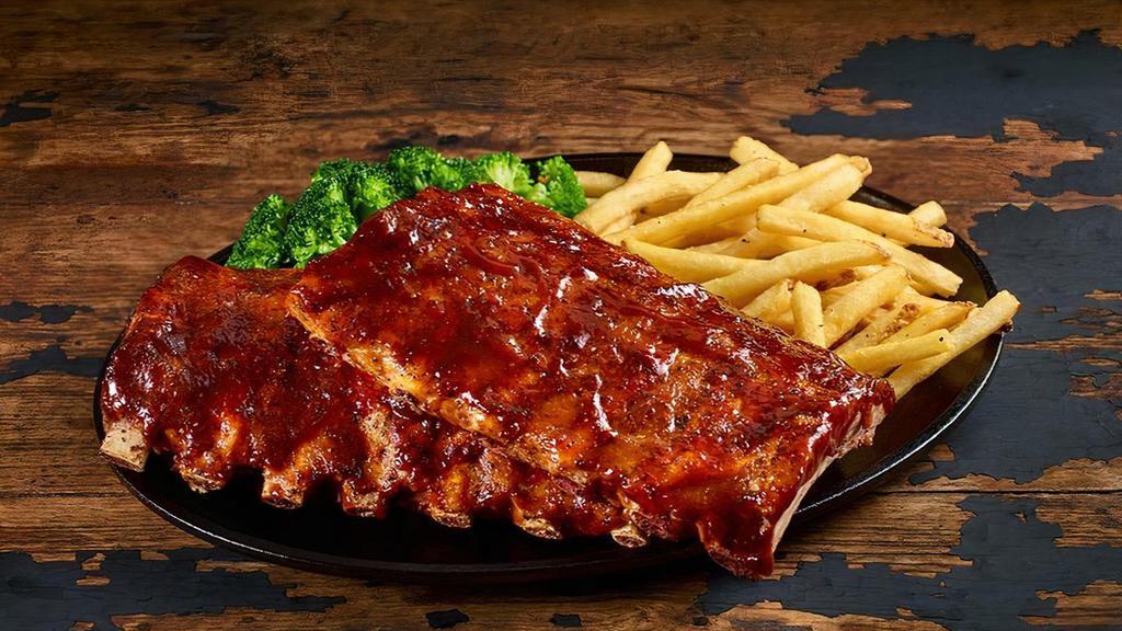 Full-Rack Baby-Back Ribs · Slow-cooked for hours until they fall off the bone. Choose Classic Barbecue, Hickory Bourbon, Nashville Hot, or Texas Dusted dry rub. Served with your choice of two sides.