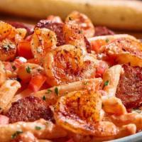 Blackened Shrimp & Sausage Pasta · Penne pasta tossed with a creamy tomato and alfredo sauce and finished with diced tomatoes. ...