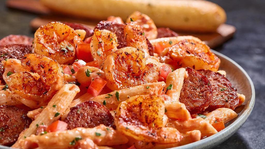 Blackened Shrimp & Sausage Pasta · Penne pasta tossed with a creamy tomato and alfredo sauce and finished with diced tomatoes. Served with a breadstick.