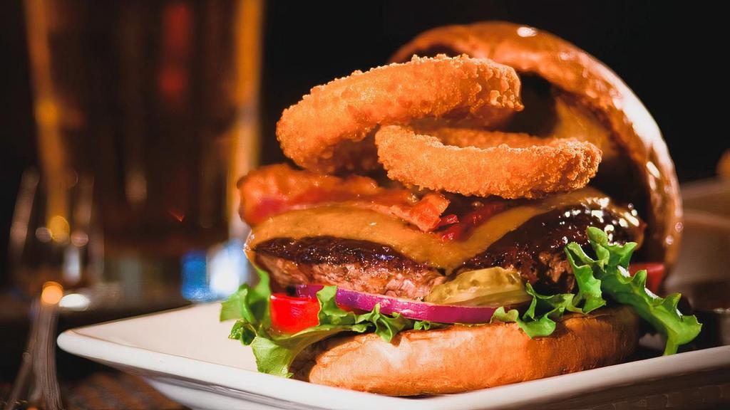 Smokehouse Cheeseburger* · Cheddar cheese, hardwood smoked bacon, BBQ sauce, and crispy onion rings.