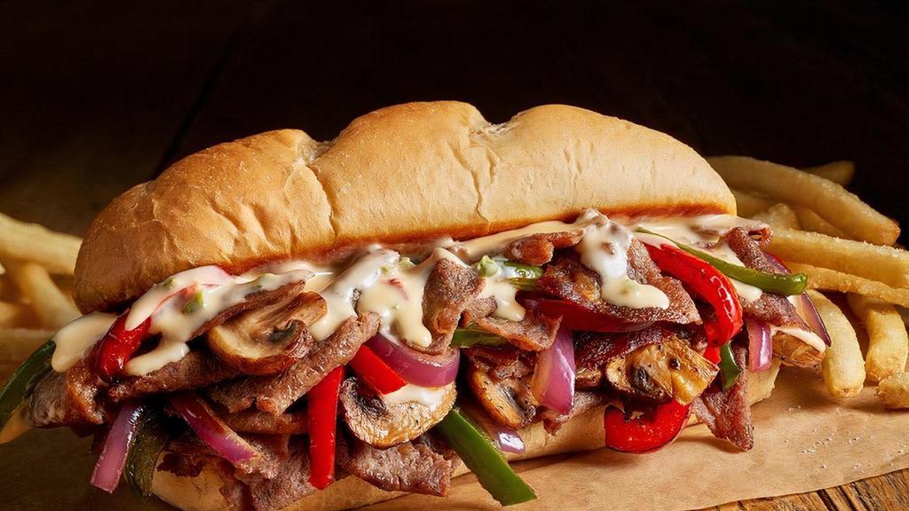 Philly Cheesesteak Hoagie · Tender, shaved beef grilled with peppers, onions, and mushrooms all topped with cheddar cheese.
