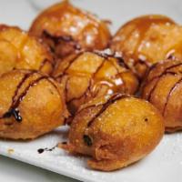 Fried Oreos · Tempura battered Oreos drizzled with chocolate and caramel.