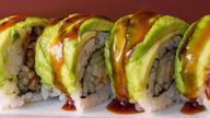 Dragon Roll · Eel, cucumber inside, avocado, tobiko on the top with eel sauce.