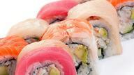 Rainbow Roll · Rolled with crab stick and cucumber avocado, topped with tuna, salmon, and yellowtail.