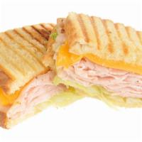 Delightful Panini · Grilled Panini Sandwich made on a European Flatbread, and topped with Honey Turkey, Swiss ch...