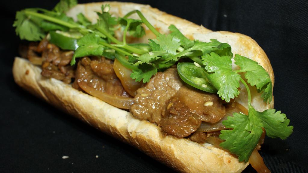 Thit Bo Satay Sandwich · Beef flank in satay and peanut sauce with onions.
Served with mayo, cucumbers, cilantro, jalapenos, pickled carrots and radish.