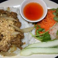 Sliced Flank Steaks Rice Plate · Steaks in satay and peanut sauce with onions (mildly hot and spicy). 
Served with lettuce, c...