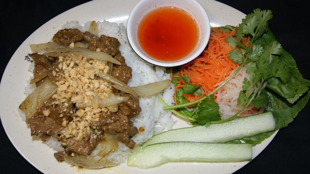 Sliced Flank Steaks Rice Plate · Steaks in satay and peanut sauce with onions (mildly hot and spicy). 
Served with lettuce, cucumbers, pickled carrots and daikons with homemade vietnamese dressing on the side.
Served over steamed white rice with crushed peanuts.