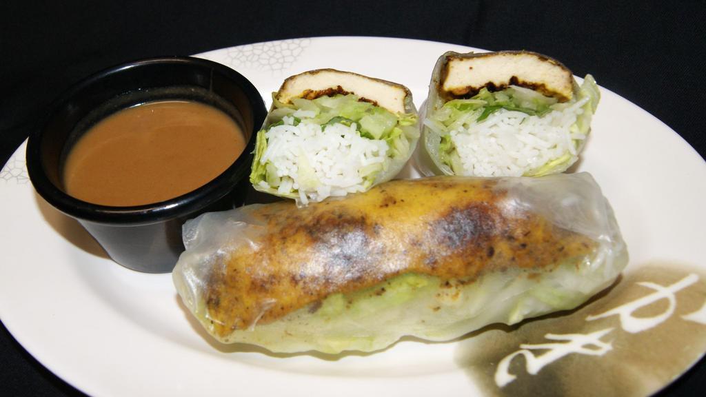 Tofu Summer Rolls · 2 rolls.
Contain rice noodles, lettuce, and basil and/or mint leaves wrapped in rice paper, served with a side of homemade peanut sauce.