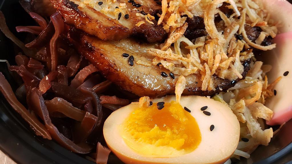 Tonkotsu Ramen   · Pork broth. Braised chasu. Boiled egg, woodear mushrooms. Naruto, black garlic truffle oil, scallions and sesame seeds.