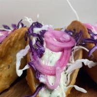 Nada-Taco · (3) Cheese empanadas filled with fried
chicken or ground beef, cabbage, pickled
onion, pink ...