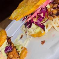 Pataconsito  · Crispy chicken fried plantain sandwich,
mozarella cheese, cabbage, pickled onion , and our s...