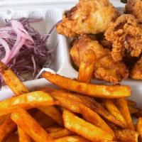 Pio Pio Pio · Crispy seasoned boneless chicken bites with choice of fries or fried plantains, pink and cil...