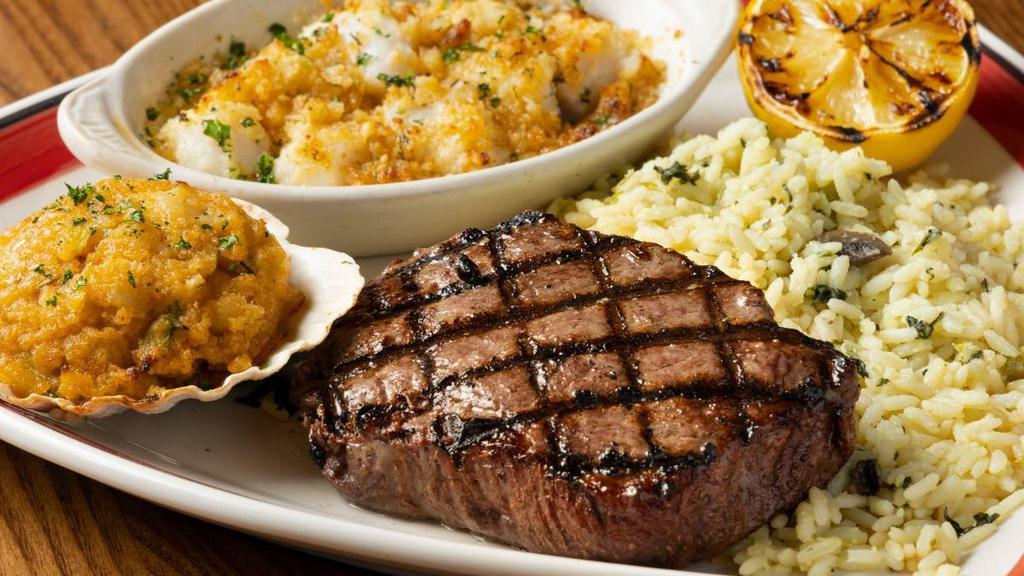 3-Way Sirloin* & Baked Scallops Combo With Seafood Stuffie · A tender and juicy 8 oz. Top Sirloin flame broiled to perfection paired with North Atlantic sea scallops baked with seasoned cracker crumbs and butter. Served with a Seafood Stuffie and one side.