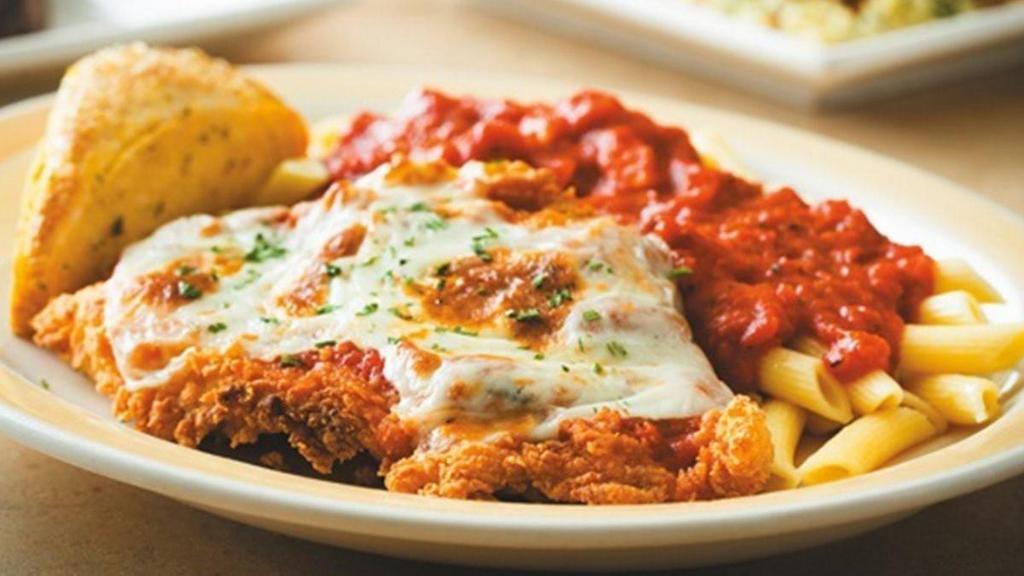Chicken Parmigiana · A hand-breaded crispy chicken breast topped with classic tomato sauce and melted mozzarella cheese. Served with penne pasta and warm Rustic Bread.
