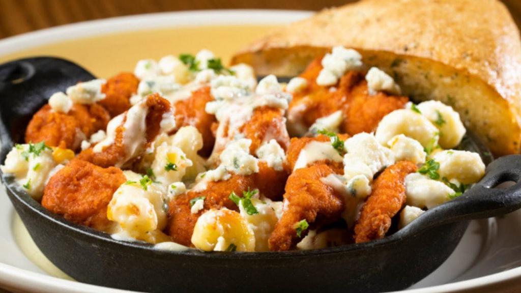 Honey Bbq Chicken Mac & Cheese · Skillet baked creamy cavatappi Mac & Cheese topped with crispy hand-breaded chicken tossed in our Honey BBQ sauce, drizzled with Sriracha ranch sauce and topped with bleu cheese crumbles. Served with warm Rustic Bread.