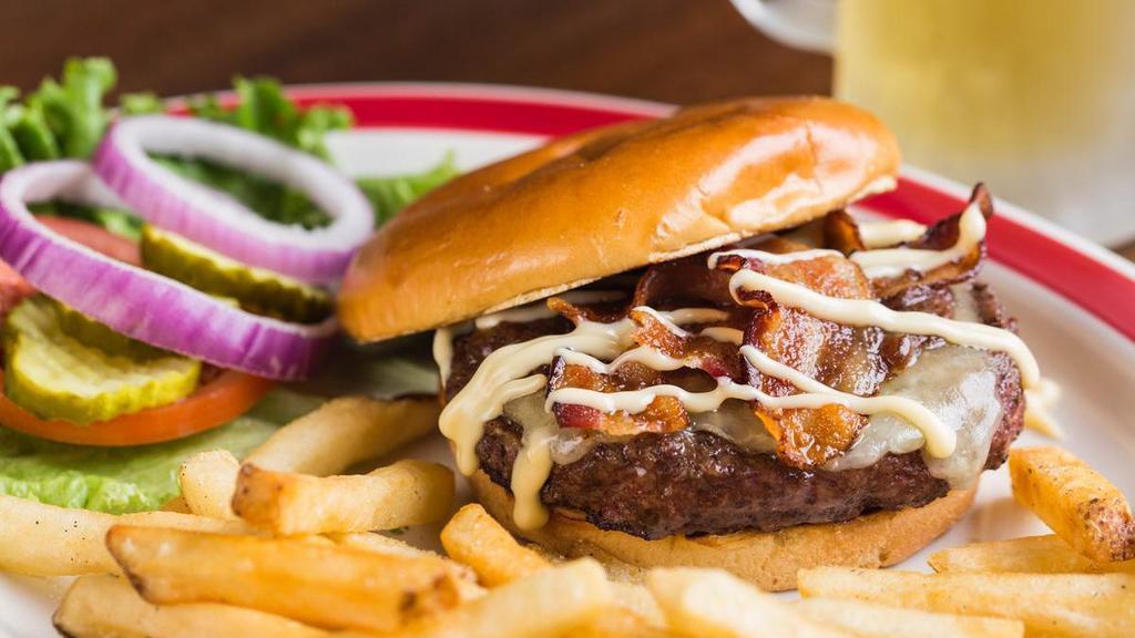 Vermont Cheddar Burger* · Jam-packed with the taste of New England. Vermont Cheddar cheese, caramelized onions, applewood smoked bacon and real Vermont maple mayonnaise. Served with choice of one side.