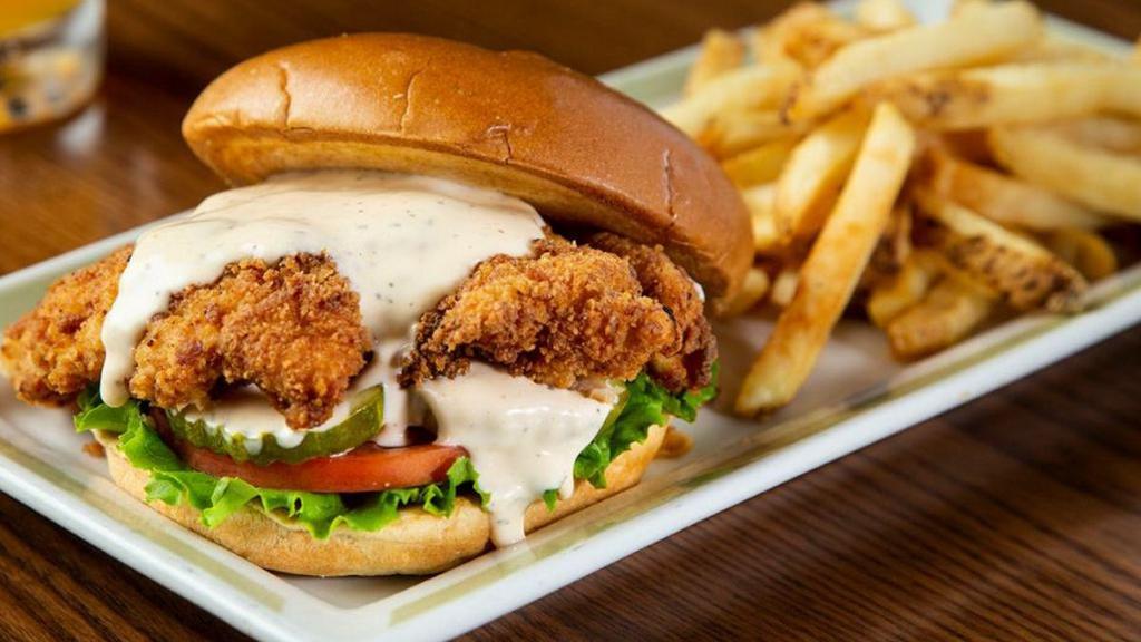 Spicy Crispy Chicken Sandwich · Crispy buttermilk tabasco-breaded chicken breast drizzled with spicy Sriracha ranch sauce stacked with lettuce, tomato and pickles. Served on a brioche bun with choice of one side.