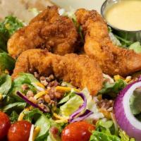 Crispy Honey Mustard Chicken Salad · Hand-breaded crispy chicken tenders on a bed of fresh mixed greens. Topped with applewood sm...