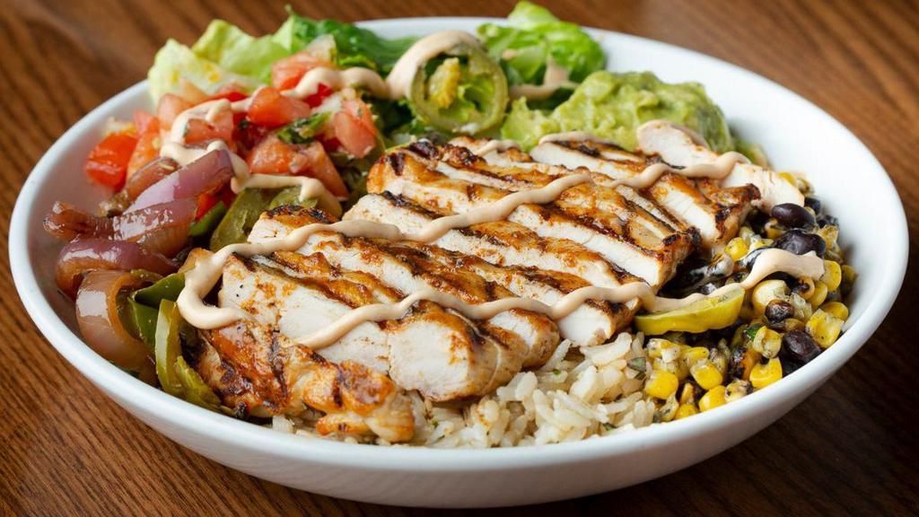 Southwest Fajita Chicken Bowl · South of the border style with sautéed onions and peppers, crisp romaine, corn, black beans, fresh pico de gallo, guacamole, jalapeños and steamed brown rice. Topped with fresh cilantro, chipotle sauce and seasoned chicken.