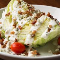 Double Bleu Iceberg Wedge · A wedge of crisp lettuce topped with tomatoes, crumbled bleu cheese and applewood smoked bac...