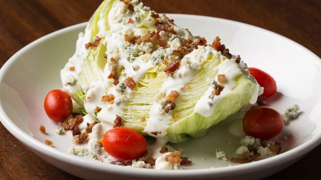 Double Bleu Iceberg Wedge · A wedge of crisp lettuce topped with tomatoes, crumbled bleu cheese and applewood smoked bacon. Served with creamy bleu cheese dressing.