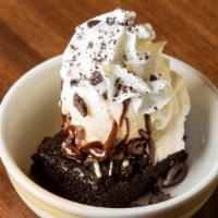 Little Midnight Fudge Hero Sundae · Chocolate cake with Oreo® cookie pieces inside. Served with creamy vanilla bean ice cream, h...