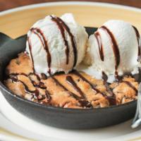 Baked Chocolate Chip Cookie Skillet · A warm and gooey New England classic. A fresh skillet-baked chocolate chip cookie topped wit...