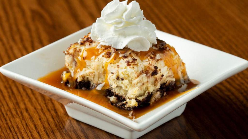 Banana Coconut Caramel Petite Treat · A chocolate cookie crust topped with banana cream, toasted coconut and chocolate drizzle. Finished with whipped cream and caramel sauce.