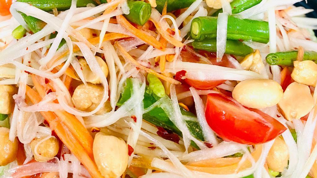 Papaya Salad · Shredded green papaya, tomato, string bean, carrot, and peanut in fresh chili lime juice on a bed of lettuce.