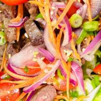 Grilled Beef Salad · Grilled beef sirloin, tomato, red onion, carrot, cilantro, scallion, lettuce. In tangy lime ...