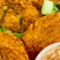 Red Curry Fish Cakes · Spicy red curry paste fish cakes mixed with string bean and kafir lime. Served with sweet ch...