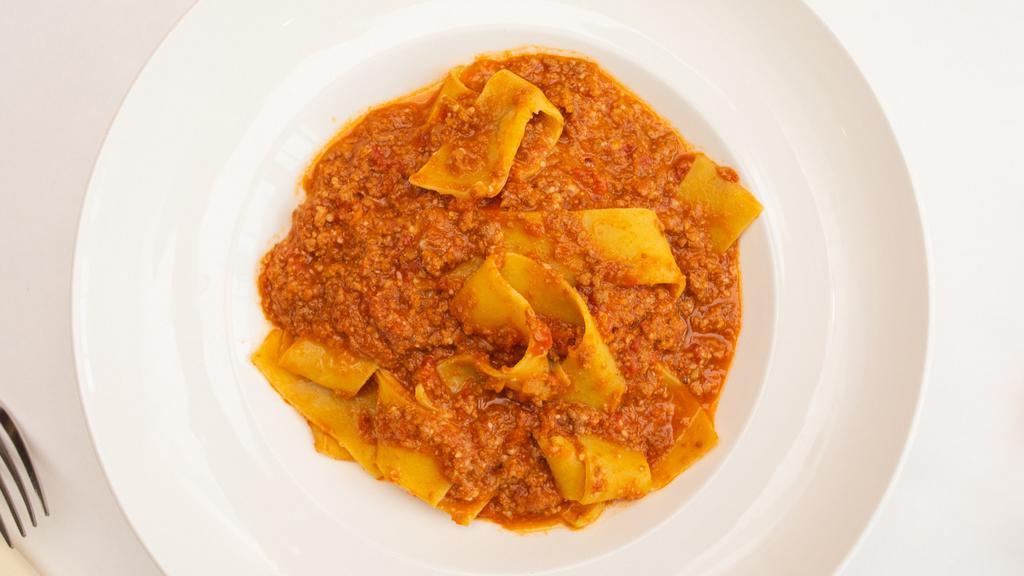 Pappardelle Bolognese · Homemade pasta in a meat sauce.