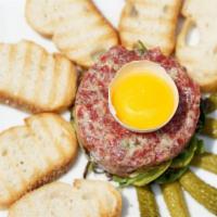Steak Tartare · Filet, shallot, capers and egg yolk, with baguette and french fries