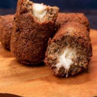 Kibbeh Croquette | Quibe · This traditional-sized kibbeh is a dish made of wheat, fresh spices, and finely ground lean ...